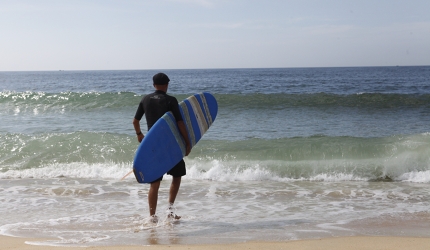 Brendan, who runs Riyue Bay Surf Club, heads for the water