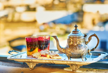 Enjoy a cup of Moroccan mint tea and sweets in Marrakech.