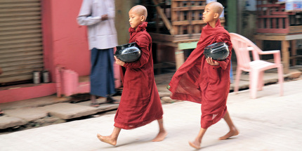 Novice monks walk through the streets of Yangon