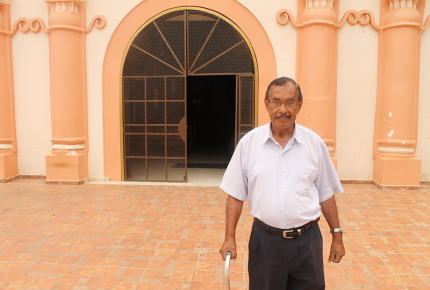 Professor Hector Rodas stands outside Yoro's Santiago de Yoro church