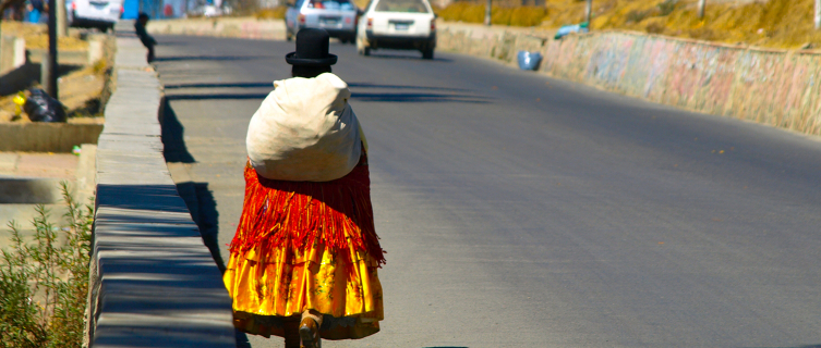A cholita walking along the streets of El Alto