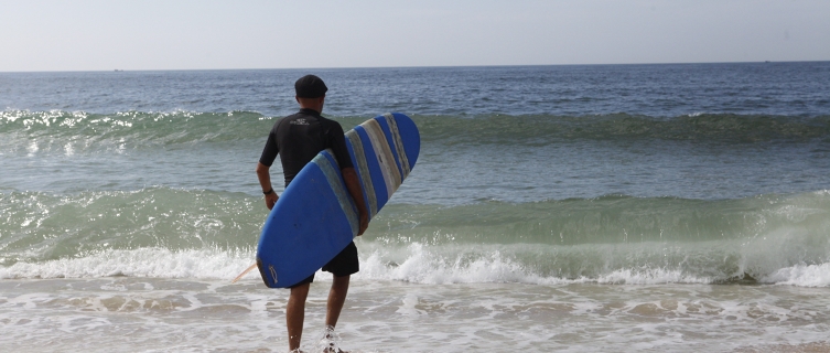 Brendan, who runs Riyue Bay Surf Club, heads for the water