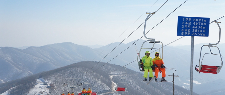 Ski instructors wear bright yellow and orange suits