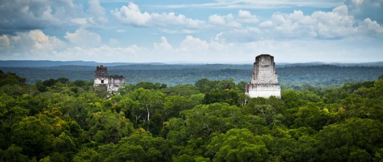 The lost city of Tikal punctuates the jungle canopy in Guatemala