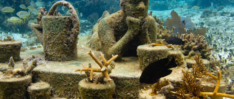 The statues are slowly forming a coral reef