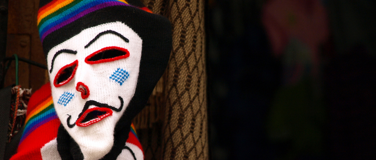 Waq'ollo masks hang in a Peruvian market