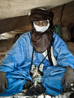 Robed Taureg man resting in tent outside Timbuktu @ © Bryony Sheamur Photography