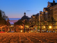 Three bikes on the canal bridge in Amsterdam © Creative Commons / joiseyshowaa