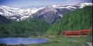 Snow-capped peaks on Norway's Bergensbanen rail trip © Rune Fossum