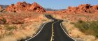 Blacktop winding through red rocks near Valley of Fire State Park in Nevada